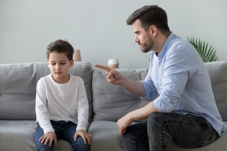 Father yelling at his son while teaching about parenting and anger management and emotional control in family relationships.
