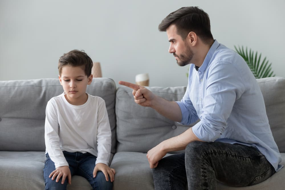 Father yelling at his son while teaching about parenting and anger management and emotional control in family relationships.