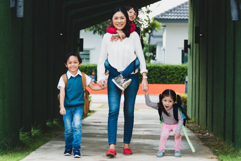 Mother walking with her children, illustrating motherhood, parenting sacrifice, and the message “It’s worth it.”