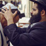 Jewish men wearing tefillin during prayer connected to the Shema Yisrael and Deuteronomy 6 covenant teachings