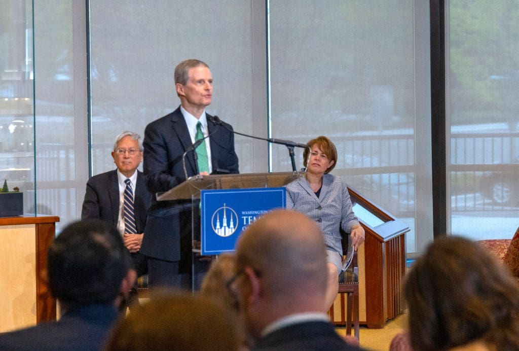 Gong, Bednar at podium, Anne Golightly, public communications chair of committee