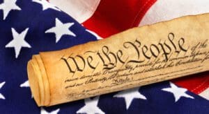 United States Constitution on American flag representing the inspired Constitution, Founding Fathers, liberty, religious freedom, and American government
