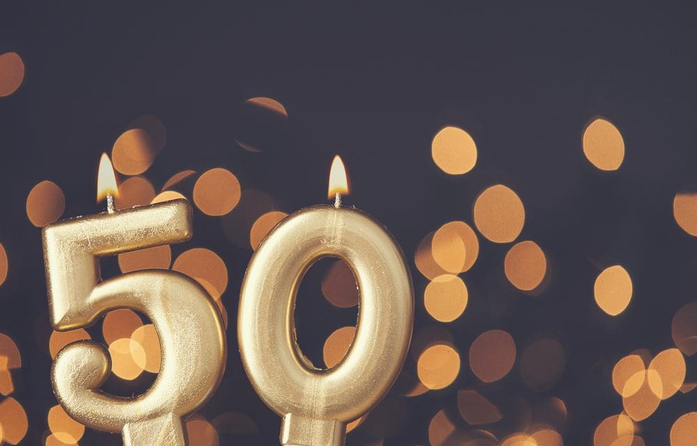 Golden 50th anniversary candles burning brightly, representing a half-century of love, commitment, and a gospel-centered marriage.