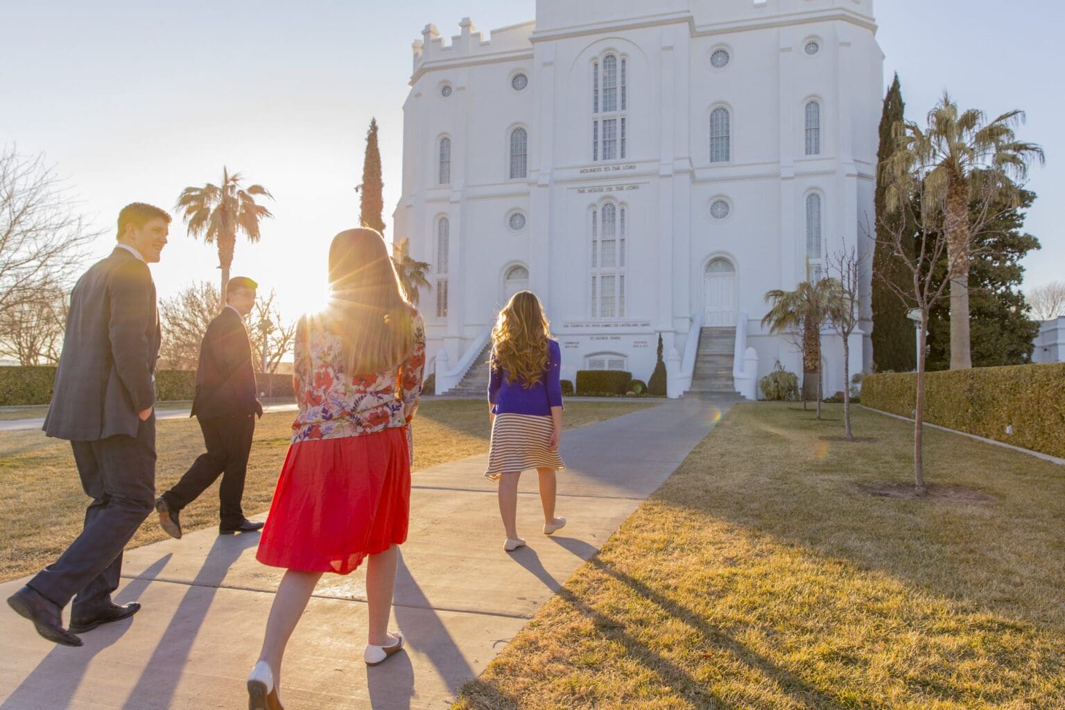 A family walking toward the St. George Utah Temple, representing faith, family unity, and the enduring importance of temple worship.
