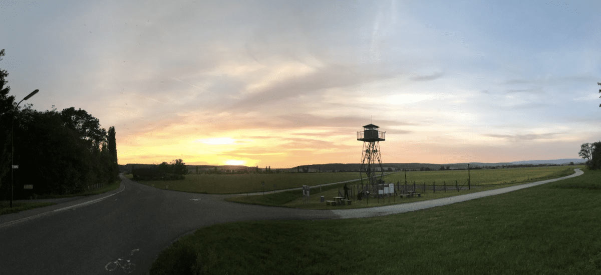 Sunset over the historical Iron Curtain watchtower in Bildein, Austria, symbolizing the village’s legacy of compassion and unity.