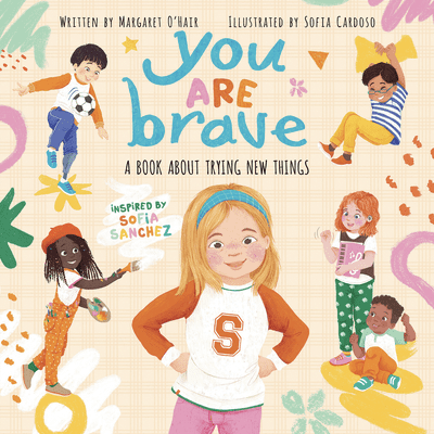 A cheerful book cover showing diverse children engaging in various activities with the central character, a confident young girl with blonde hair and an orange “S” on her shirt.