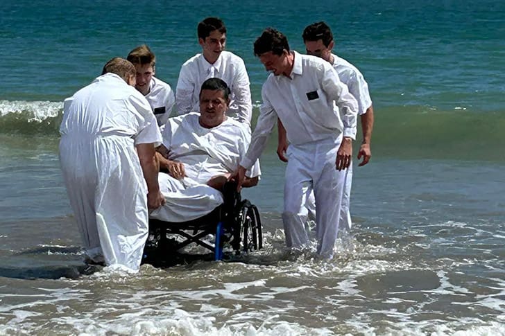 An ocean baptism in Puerto Rico, where LDS missionaries assist in the sacred ordinance, showcasing the faith and commitment of new converts.