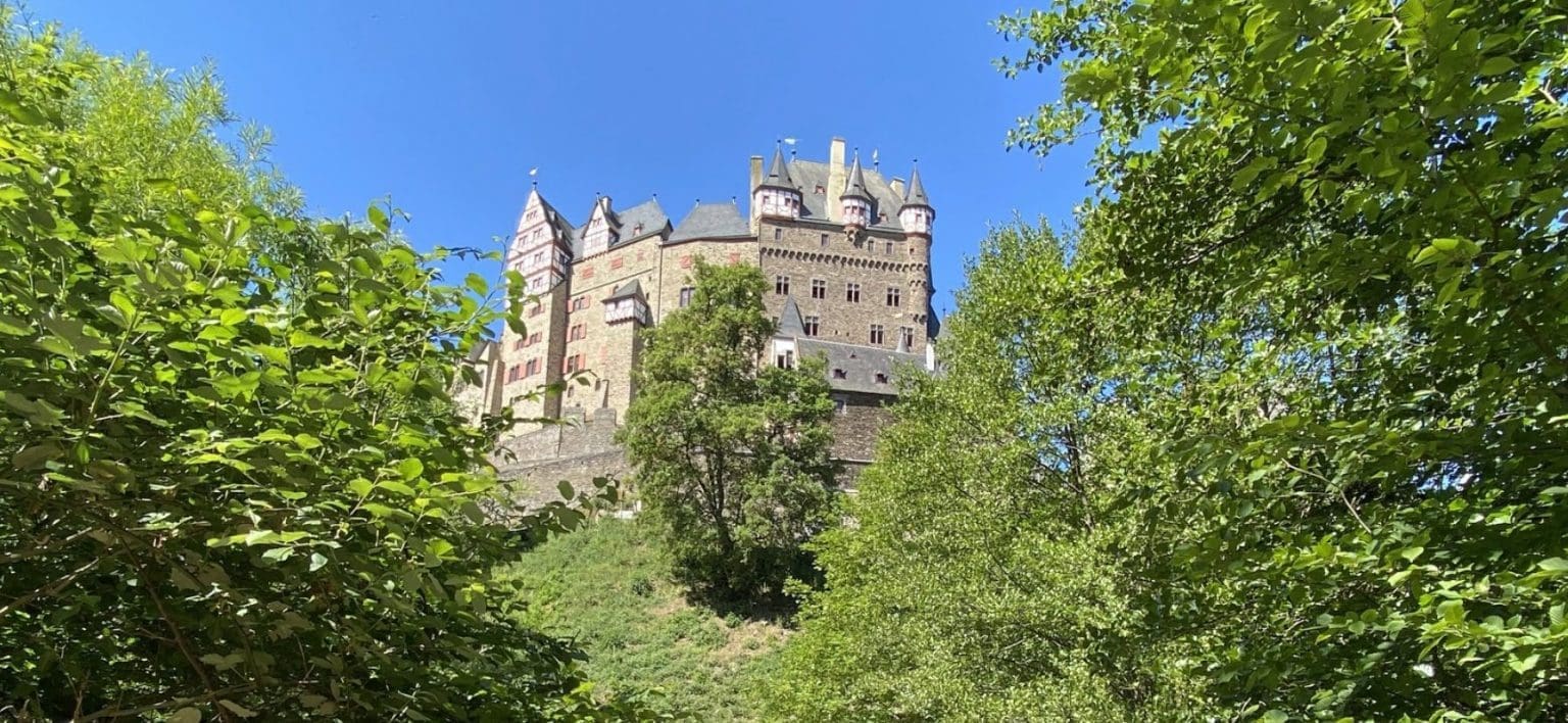 Burg Eltz castle nestled in greenery, symbolizing strength and a solid foundation in Christ.