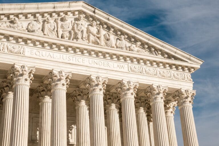 Supreme Court building with columns and "Equal Justice Under Law" engraving, symbolizing the Title IX legal battle over gender identity and school sports.