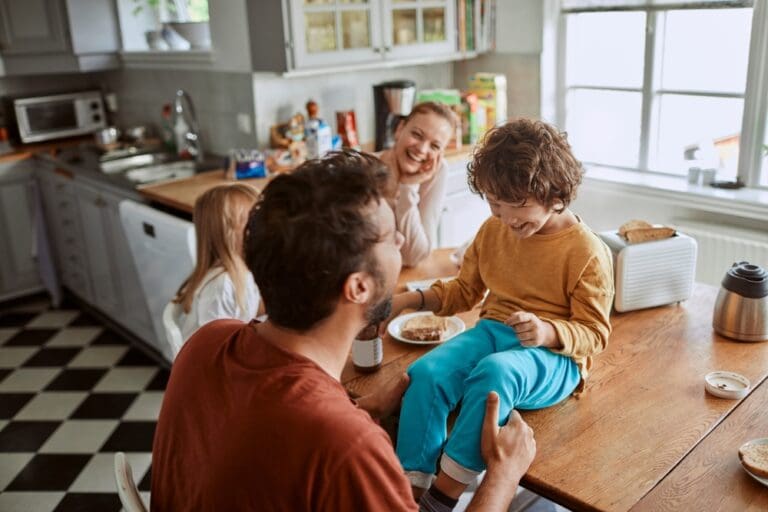 Family enjoying quality time in the kitchen, demonstrating the positive impact of true parental power and nurturing relationships.