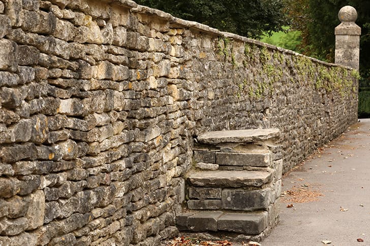 Original stone steps in Castle Combe, once used for riders to easily mount or dismount from their horses, part of the village’s centuries-old history.