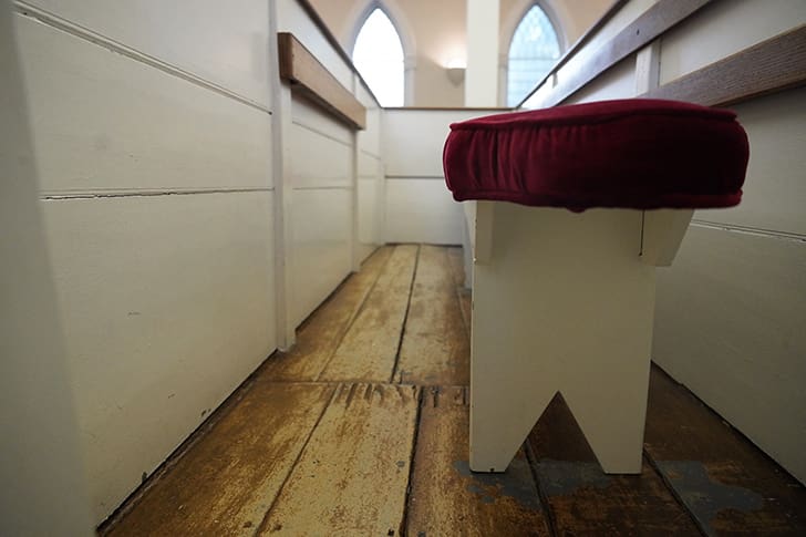 Close-up view of wooden pews in the Kirtland Temple, representing the simplicity and beauty of this historic Church site.