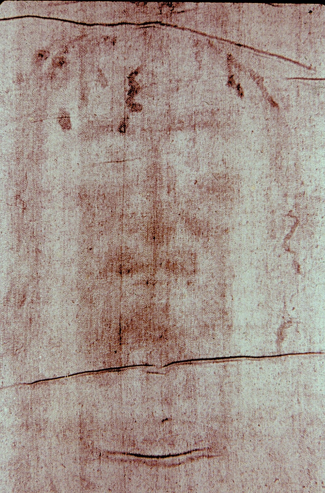 Close-up image of the Shroud of Turin’s facial depiction, a controversial relic linked to Jesus Christ’s burial cloth.