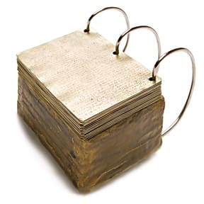 A close-up view of metal plates resembling the Book of Mormon gold plates, a significant Later-day Saint artifact giving a testament of Jesus Christ.