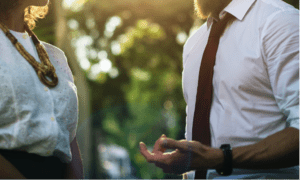 Two people having a meaningful conversation outdoors, demonstrating the principles of Appreciative Inquiry and productive communication.