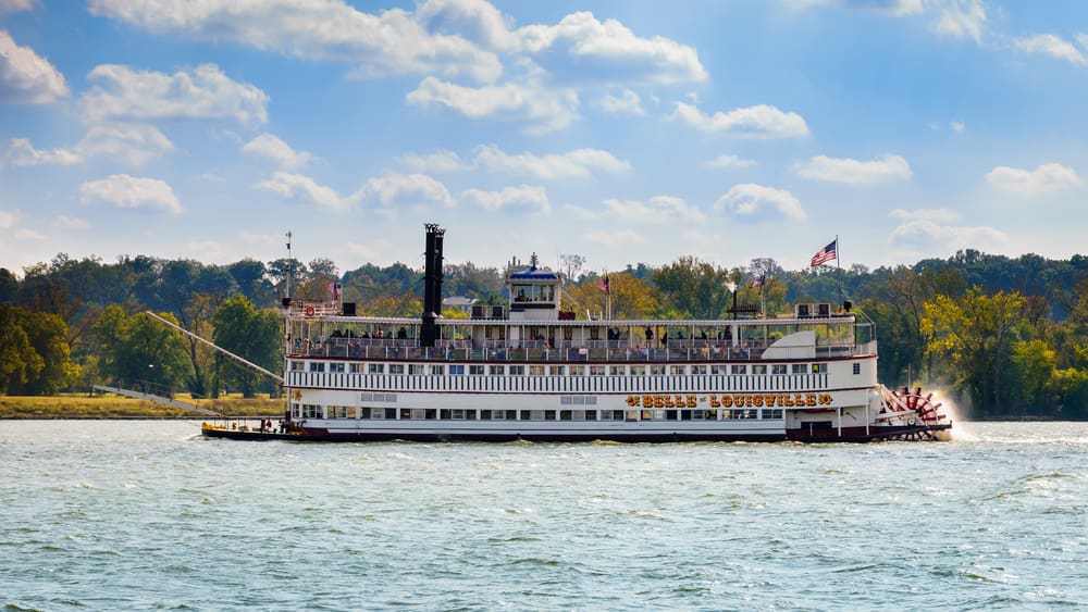 Paddlewheel steamboat cruising on the Mississippi River, evoking 19th-century riverboat history.