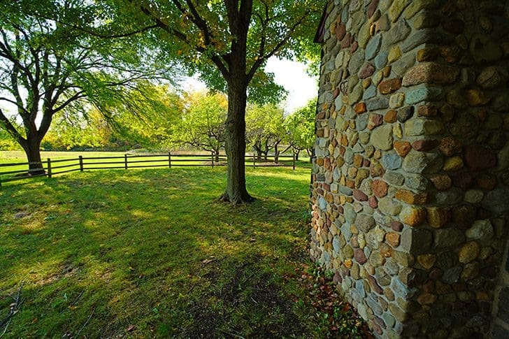 Scenic view of a meadow and stone building, reminiscent of Harmony, Pennsylvania, where Joseph Smith and Oliver Cowdery were visited by John the Baptist.