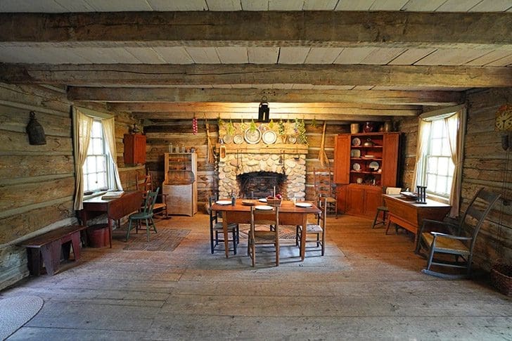 Log home interior with rustic furnishings, symbolizing the early days of The Church of Christ and the setting of Doctrine and Covenants 20-22.