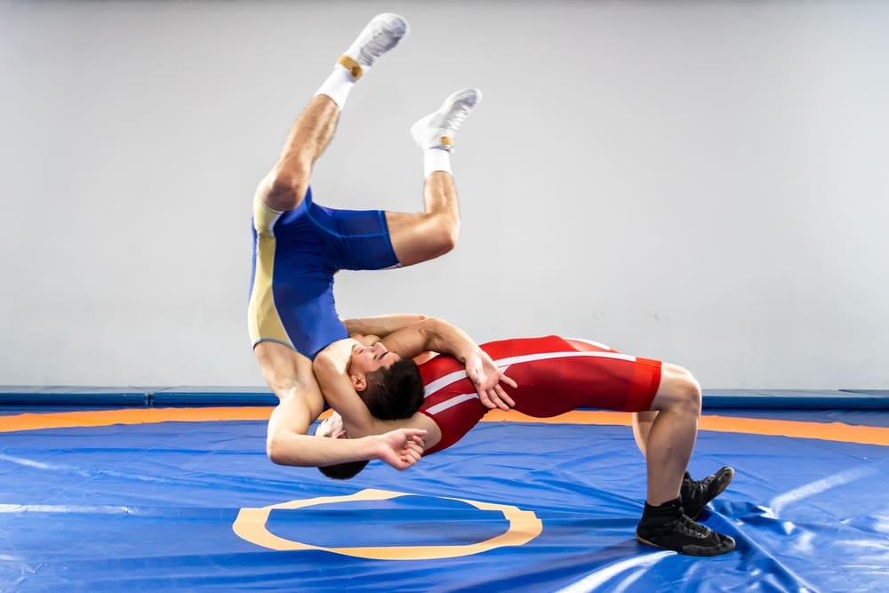 Two wrestlers in action, showcasing intense skill and technique in a competitive high school wrestling match.