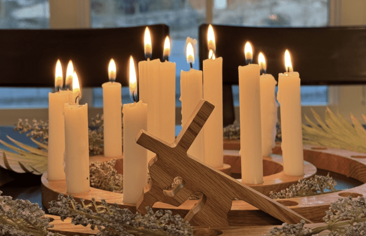 Holy Week candle wreath with cross centerpiece symbolizing Easter traditions and the final days of Jesus Christ.