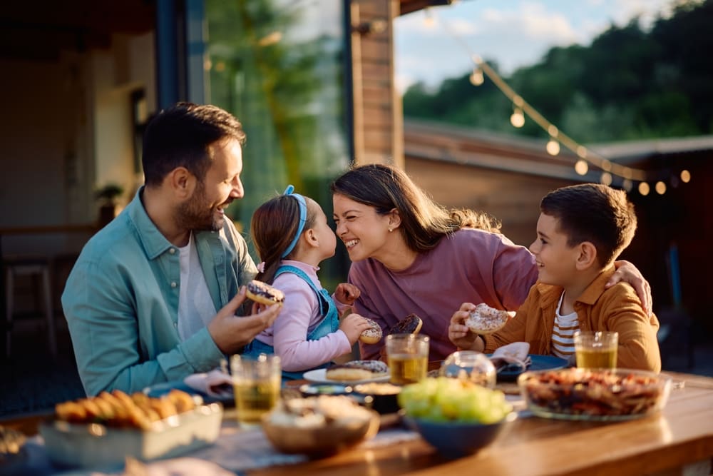 Latter-day Saint (LDS) family eating together outdoors, highlighting eternal family bonds and the need for Christ-centered parenting in today’s world.