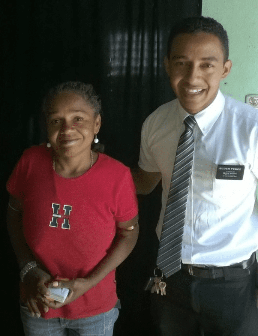 Elder Perez, a missionary in the Dominican Republic, stands smiling beside his birth mother after a miraculous street encounter.