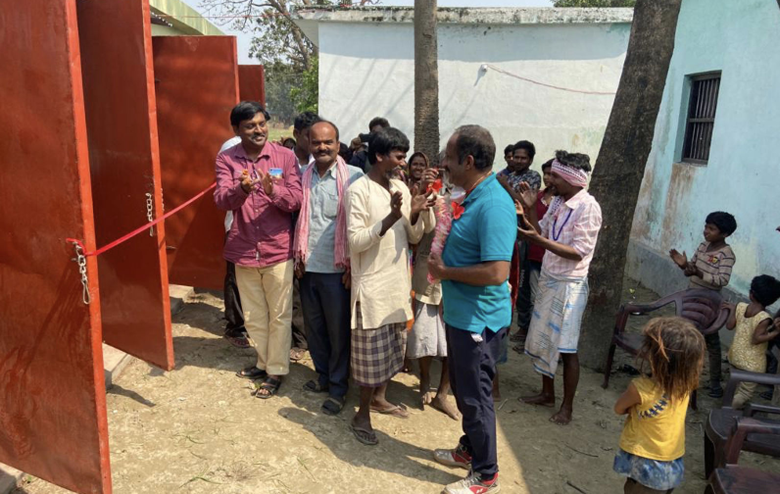 Villagers in India celebrate new toilet and shower facilities built through a service project to improve sanitation and health in a leprosy colony.