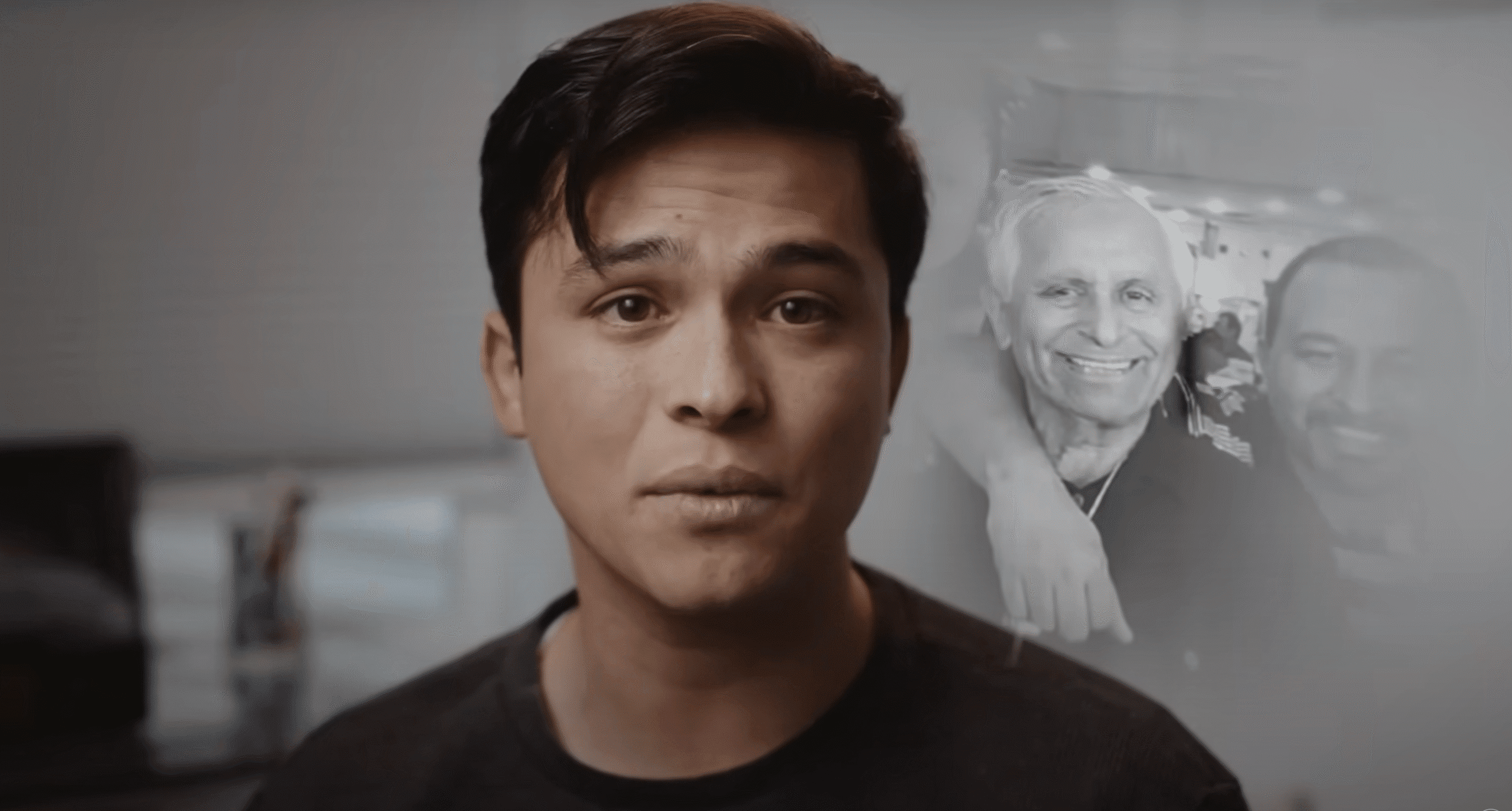 Young man shares his story with a photo of his grandfather in the background, symbolizing healing through family history.