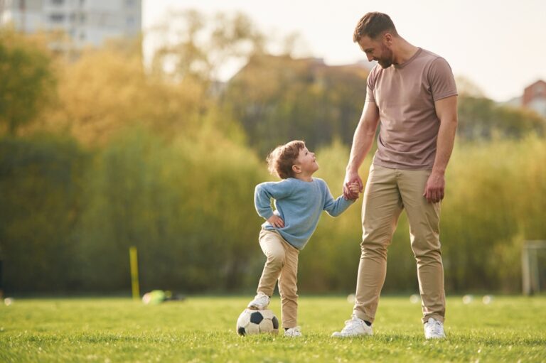 Man and young boy bonding outdoors, symbolizing childless Latter-day Saints forming meaningful family relationships through honorary parenting.