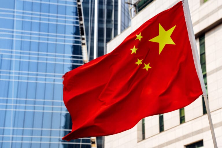 Chinese flag in urban setting symbolizing restrictions on the Church in China and foreign religious activity.