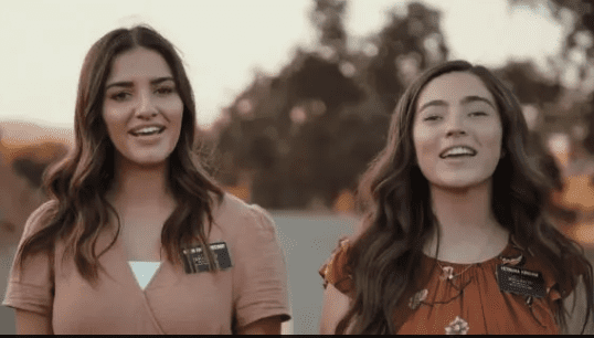 Two sister missionaries smiling, walking outdoors at sunset, symbolizing stronger relationships and emotional connection in missionary companionships.