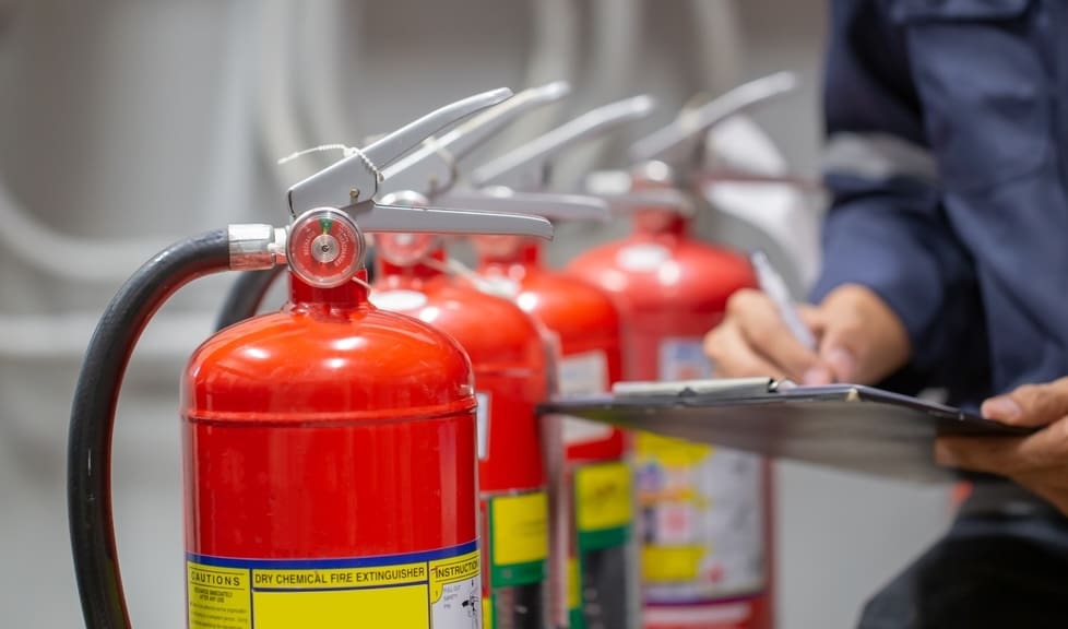 Fire extinguishers being inspected as part of wildfire preparedness planning.