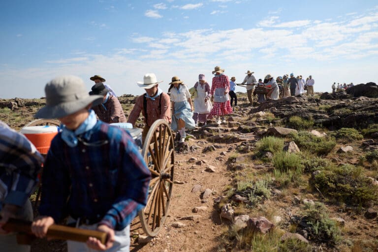 Latter-day Saint youth reenacting a pioneer trek on the Wyoming Mormon Trail with handcarts and pioneer attire