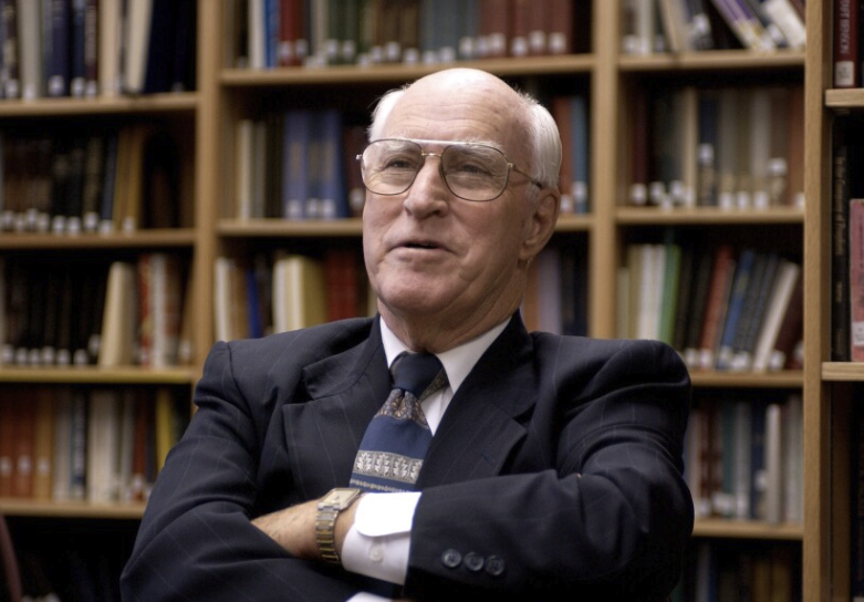 Dr. Robert J. Matthews, scholar of the Joseph Smith Translation, in a library setting