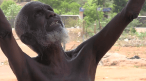 Karrupiah, a beneficiary of Rising Star Outreach in India, bows in gratitude to volunteers after receiving sight-restoring treatment and compassionate care.