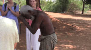 Karrupiah, a beneficiary of Rising Star Outreach in India, bows in gratitude to volunteers after receiving sight-restoring treatment and compassionate care.