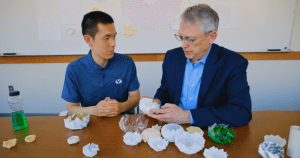  BYU professor Larry Howell and student Kelvin Wang examine origami bloom pattern models as part of origami-inspired engineering research.