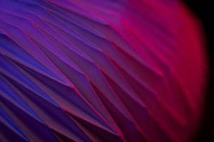 A close-up view of BYU’s newly discovered origami bloom patterns, highlighting the folded, flower-like geometry in purple and red lighting.