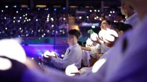 Youth participants hold glowing orbs symbolizing the Tree of Life during the Tabernacle Choir’s Argentina performance, highlighting unity and light in Christ.