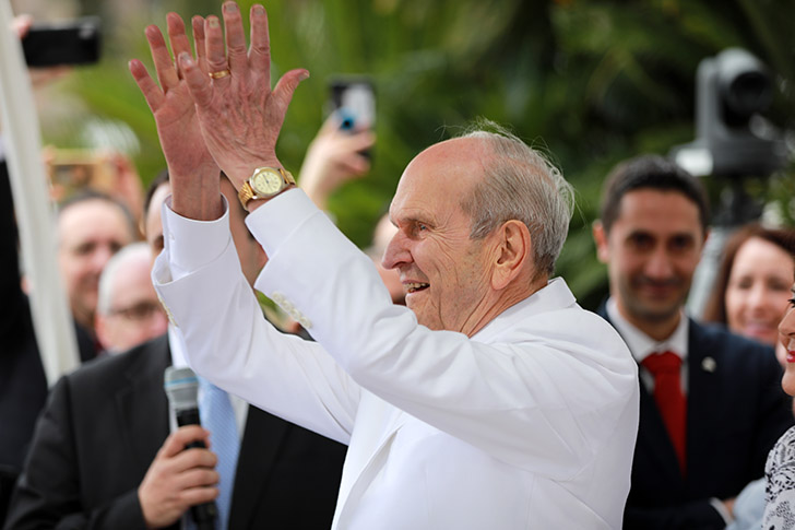 President Russell M. Nelson waves joyfully during a temple event, symbolizing his dedication to temple covenants and the gathering of Israel in the last days.