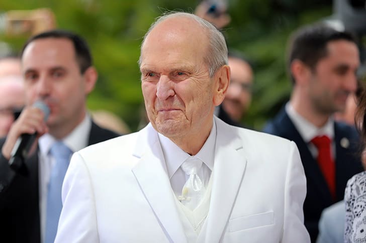 President Russell M. Nelson appears moved during a temple event, reflecting his Christlike leadership and lifelong dedication to gathering Israel and building temples.