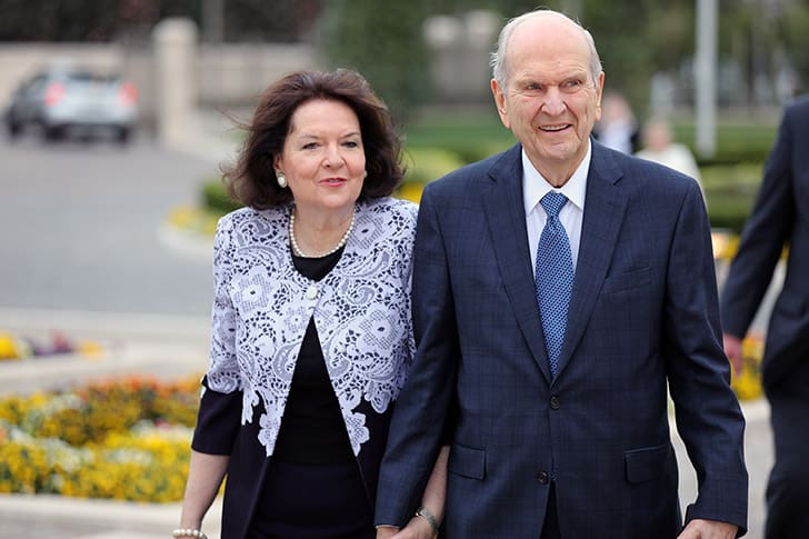 President Russell M. Nelson walks hand in hand with Sister Wendy Nelson near temple grounds, symbolizing their united devotion to the Savior and gospel service.