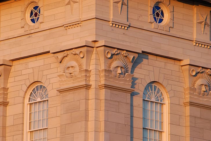 Detailed view of Nauvoo Illinois Temple sunstones at sunrise, symbolizing light and knowledge, referenced by President Russell M. Nelson’s temple teachings.