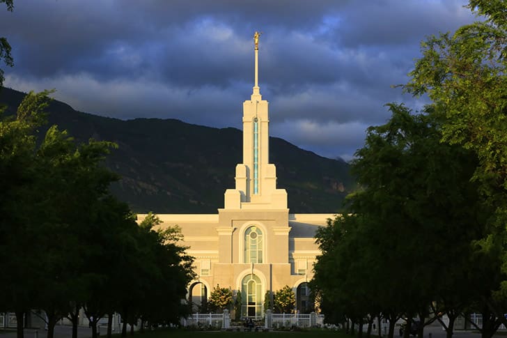 The Mount Timpanogos Temple illuminated at sunset, emphasizing President Russell M. Nelson’s promise that time in the temple brings power and peace.