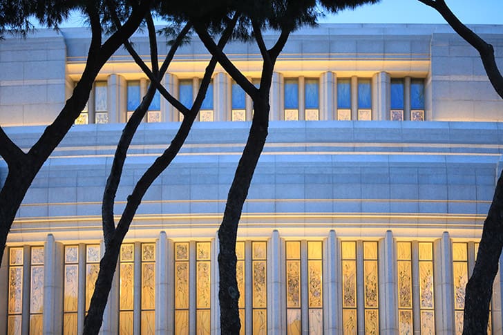  The Rome Italy Temple illuminated at dusk, framed by trees, symbolizing President Russell M. Nelson’s temple teachings on worship, covenants, and discipleship.