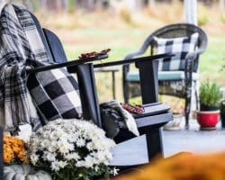 Rocking chair with plaid blanket and autumn flowers, symbolizing resilience and inspiration from Daris Howard’s story Not Sitting in Rocking Chairs.