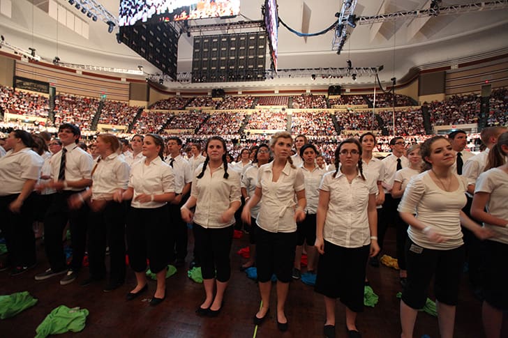 Youth assembled in a large meeting, symbolizing their prophetic role as the Lord’s youth battalion in gathering Israel.