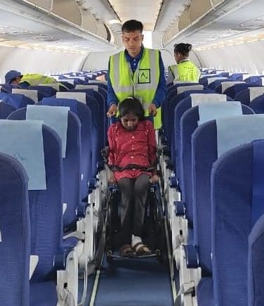 Airport staff assist Lakshmi in a wheelchair as she boards a flight to New Delhi for life-saving treatment at the Missionaries of Charity hospital. Her journey became a defining moment in the Lakshmi leprosy miracle.