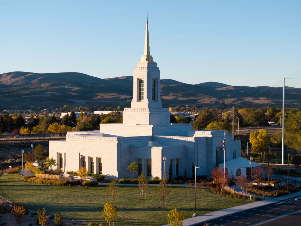The Elko Nevada Temple stands against a backdrop of Nevada mountains at sunrise, symbolizing the Elko Nevada Temple Dedication led by Elder Gary E. Stevenson and the blessings it brings to Latter-day Saints in the region.