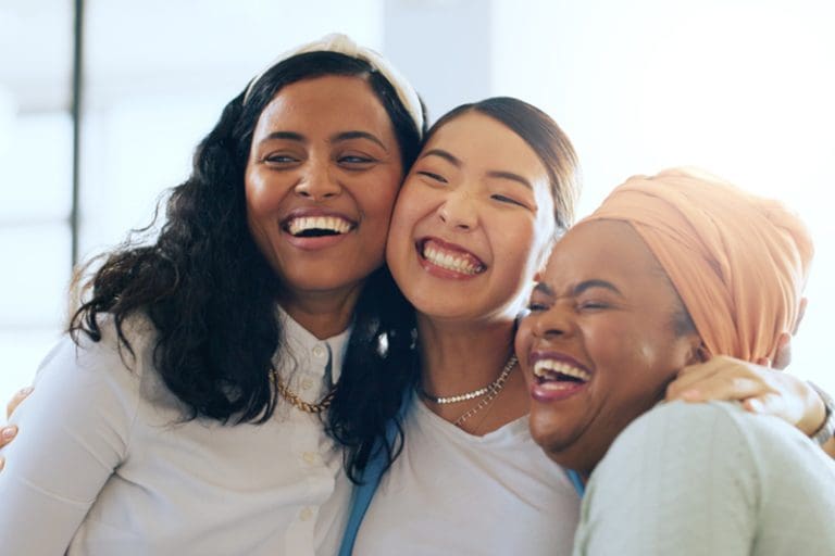 Women showing empathy and Christlike love through friendship and joy, representing the gospel of Jesus Christ and Latter-day Saint discipleship.